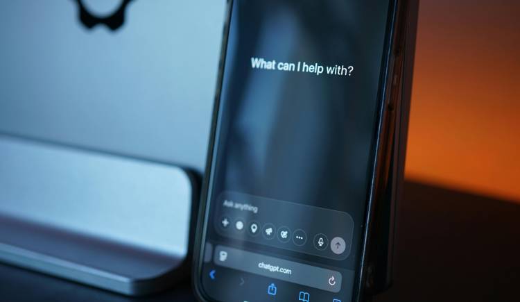 Person using a laptop and phone to manage AI-powered customer messages.