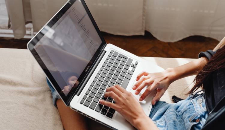 Person using a computer, representing Google Sheets work.