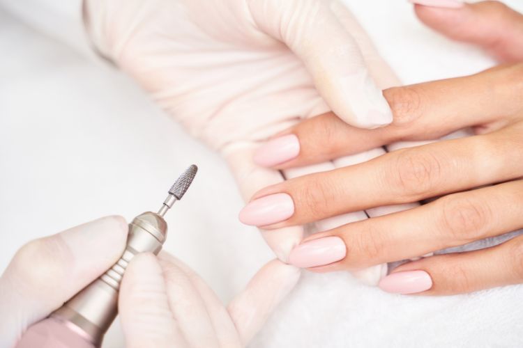 Nail technician working on clients nails