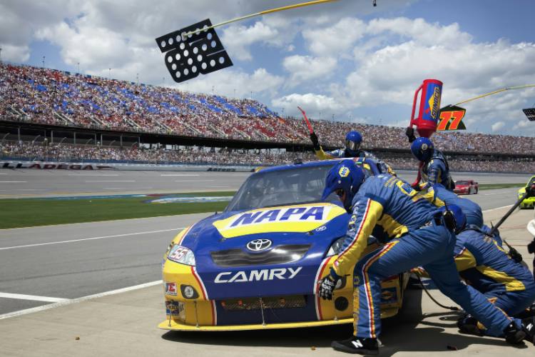 Pit crew working on a car during a race.