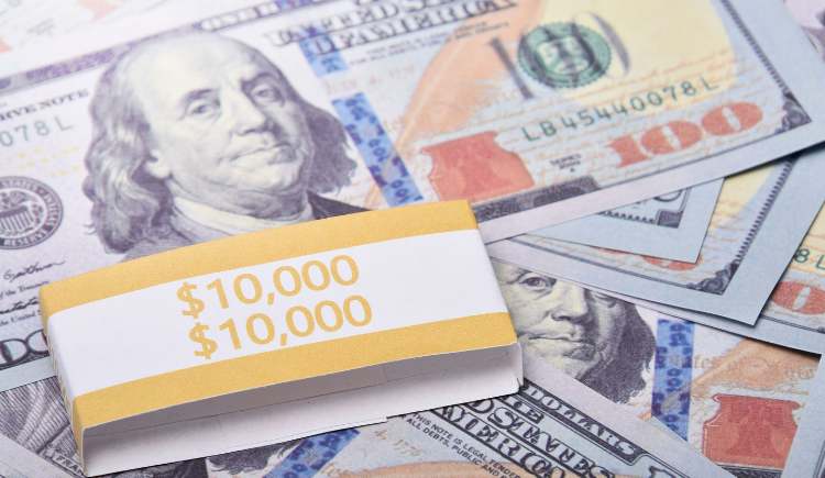A stack of $100 bills wrapped in a $10,000 band.