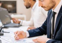Person reviewing official documents and policies on a desk