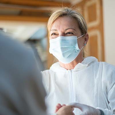 Health care worker providing care to a patient.