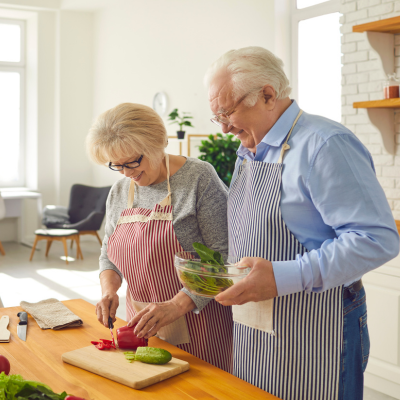 An older couple preparing a meal together.