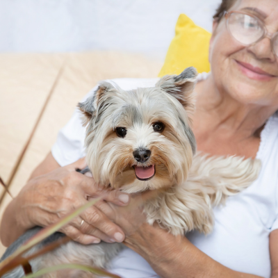 Senior holding her pet dog.